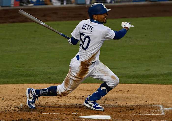 Sep 5, 2020; Los Angeles, California, USA; Los Angeles Dodgers right fielder Mookie Betts (50) singles in the third inning against the Colorado Rockies at Dodger Stadium. Mandatory Credit: Robert Hanashiro-USA TODAY Sports